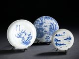 three blue and white plates with designs on them sitting on a table