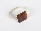 a close up of a silver ring with a brown stone on it