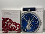 a blue and red watch and a box of red and white bracelets