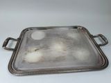 a silver tray with handles and handles on a white surface