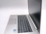 a laptop that is sitting on a white surface