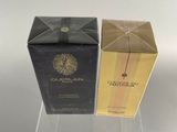two boxes of perfume sitting on top of a clear table