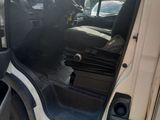 a white van with the door open on the side of the road