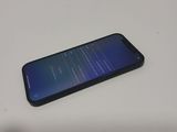 a close up of a cell phone sitting on top of a table