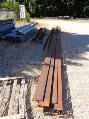 a pile of wood sitting in the middle of a field