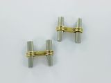 two silver and gold cufflinks with a gold clasp