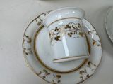 a cup and saucer sitting on a plate on a table