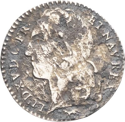une pièce d'argent portant une tête d'homme