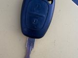 a picture of a car key hanging from the hood of a car