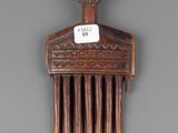 a wooden comb that has a sign on it