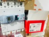 someone taking a picture of a display of electrical equipment in a glass case