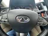 the steering wheel of a car with a person sitting in the drivers seat