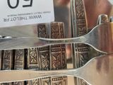 a silver plate with a fork and a knife on it