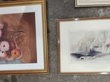 two framed pictures on the wall of a room