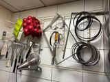 many kitchen utensils hanging on the wall in the kitchen