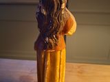 a figurine of a woman sitting on a table