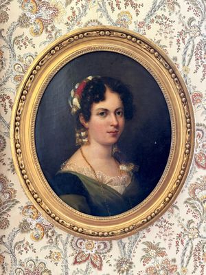 portrait d'une femme en robe verte, avec une fleur rouge dans les cheveux