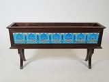 an old wooden planter with a blue and yellow design on it