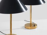 a pair of black lamps on a white table