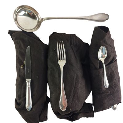 a spoon, fork, and spoon rest on a black cloth