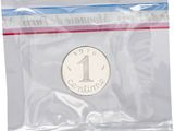 a silver coin in a plastic bag on a white background