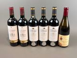 several bottles of wine are lined up on a table