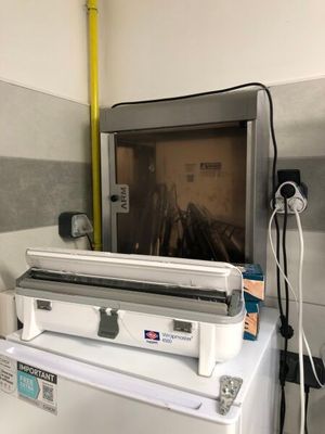 a television sitting on top of a washer in a room