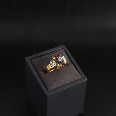 gold and diamond ring in a black box on a black background