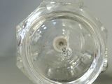 a clear glass object with a small hole in it