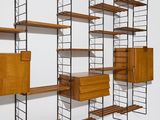 an image of a wall mounted shelving with shelves and drawers