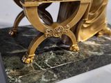 gold statue of a woman sitting at a desk with a keyboard