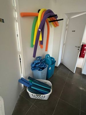 a lot of different colored hoses hanging on the wall