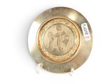 a gold plate with a picture of a man and a woman on it