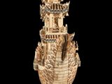 an image of a wooden sculpture of a boat with a pagoda on it