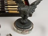 a statue of a bird on a table next to a set of tools