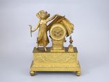une horloge en or surmontée d'une statue