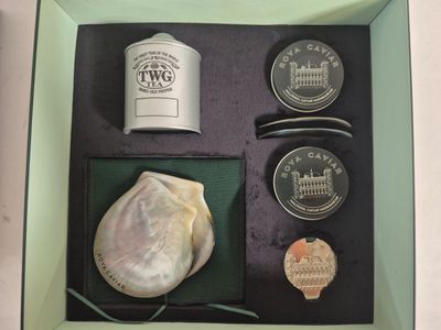 a box containing a bottle of tea, a coin, and other items