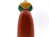 a figurine of a woman sitting on top of a red object