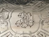 a silver tray with a monogram on it