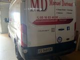 a van that is parked in a garage with the door open