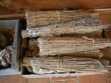 several bundles of sticks are stacked on top of each other in a box
