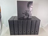 five binders stacked on top of each other on a table