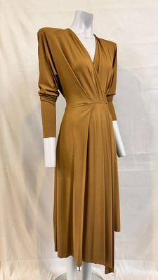 an image of a mannequin wearing a brown dress on a mannequin stand