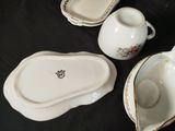 three pieces of china on a table with a black background
