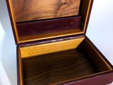 an open wooden box sitting on top of a white surface