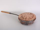 strainer with wooden handle on a white surface