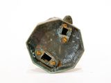 a metal object that is sitting on a white surface