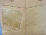 beige leather tote bag sitting on top of a blue table
