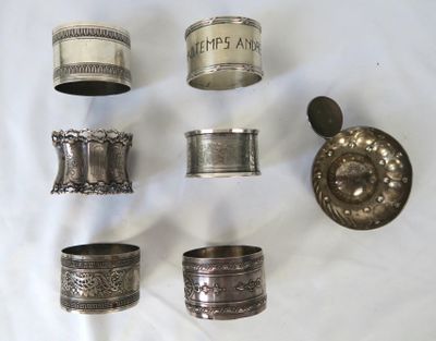 a lot of silver rings and napkins on a table