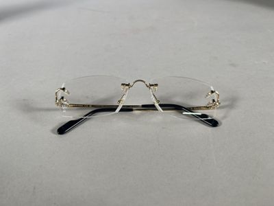 pair of glasses on a table with a white background
